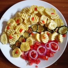 A picture of Banana, potatoes and zucchini fries.