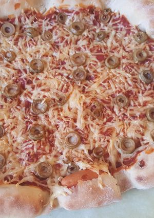 Une photo de Pizza à la saucisse et tomate oignon