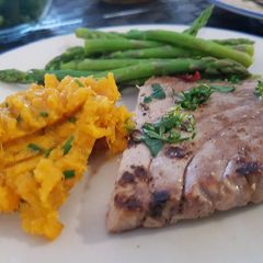 A picture of Grilled tuna with sweet potato mash and asparagus.