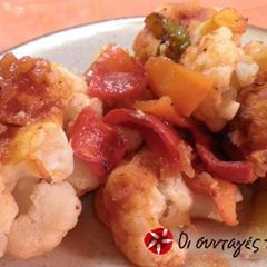 A picture of Cauliflower with tomato sauce in the oven.