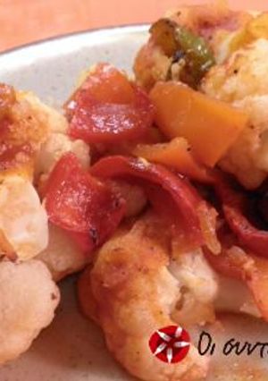 A picture of Cauliflower with tomato sauce in the oven.