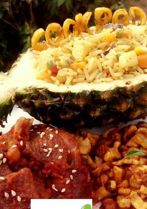 A picture of Pineapple Fried Rice with peppered chicken and fried plantain.