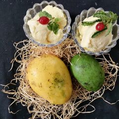 A picture of Raw mango and ripe mango ice cream (with milkmaid and fresh cream).