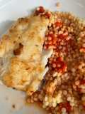 Fried fish with couscous and tomato sauce