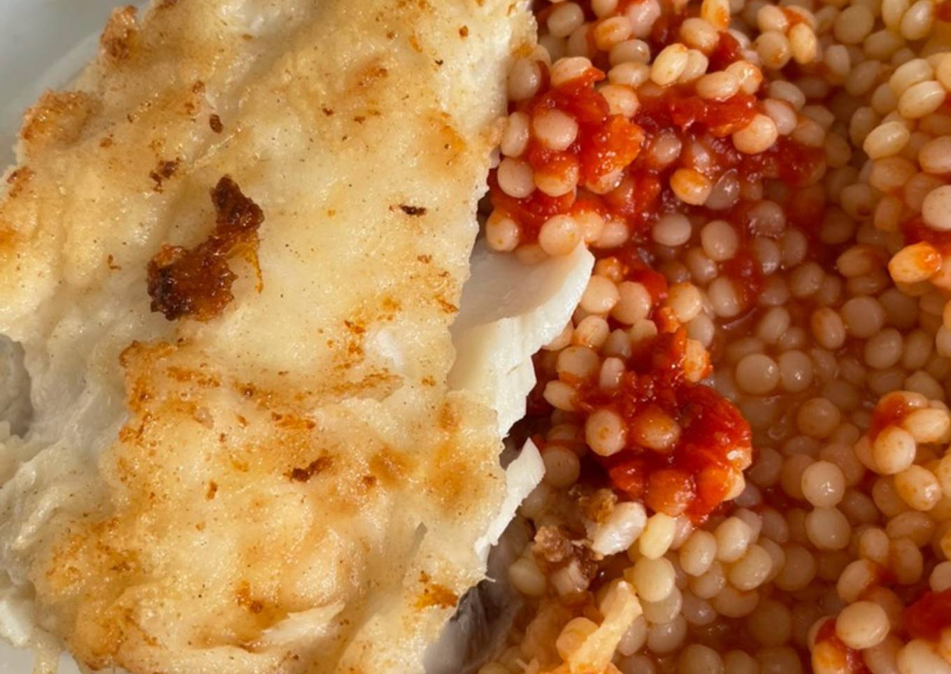 Fried fish with couscous and tomato sauce