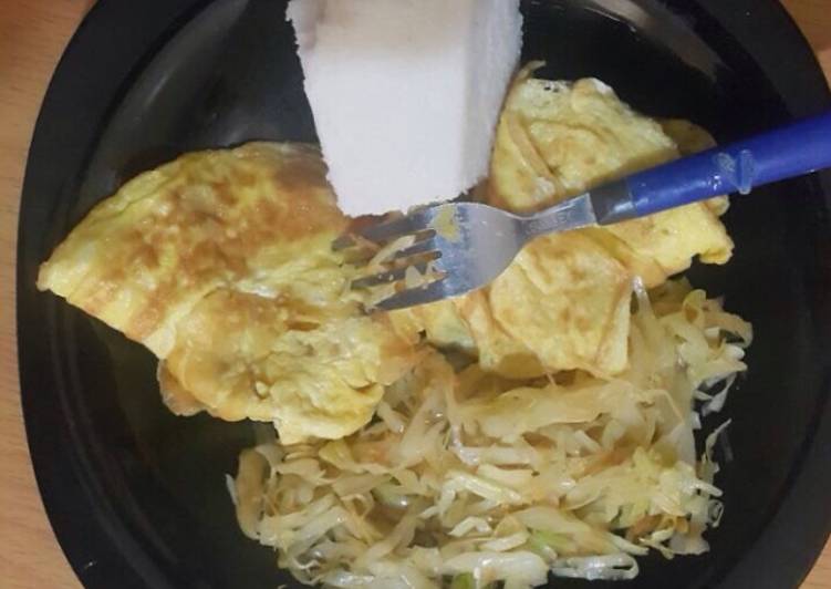Ugali served with fried eggs and steamed cabbage
