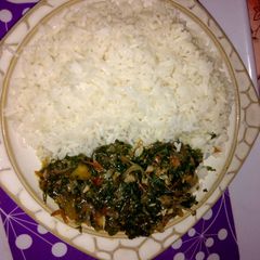 A picture of White rice with vegetable sauce.