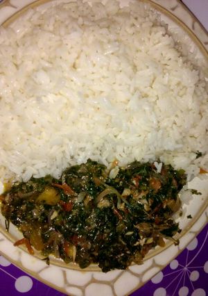 A picture of White rice with vegetable sauce.