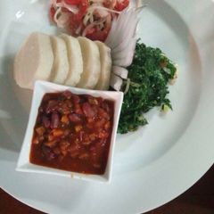 Ugali served with beans stew and vegetables A picture of Ugali served with beans stew and vegetables.