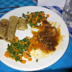 A picture of Chapati with mixed veggies and beef.