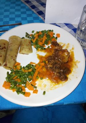 A picture of Chapati with mixed veggies and beef.