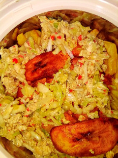 A picture of Egg and cabbage sauce with chips and plantain.