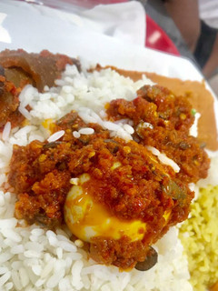 A picture of Rice and pepper sauce with pomo and boiled egg.