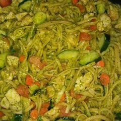 A picture of Chicken vegetables and pesto sauce pasta.