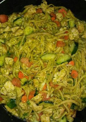 A picture of Chicken vegetables and pesto sauce pasta.