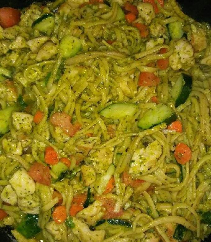A picture of Chicken vegetables and pesto sauce pasta.