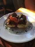 Open Faced Steak Sandwiches on Garlic Bread with Aged Provolone, Caramelized Onions, and Parsley Oil