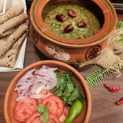 A picture of Five ingredients Daal Palak in handi.