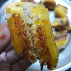 A picture of Pazham Nirachathu – Banana with sweet coconut filling.