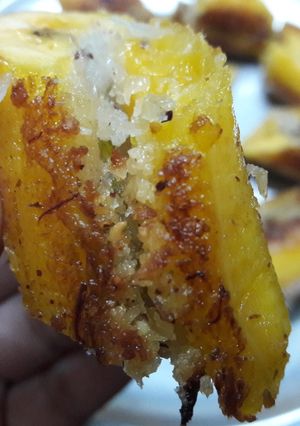 A picture of Pazham Nirachathu – Banana with sweet coconut filling.
