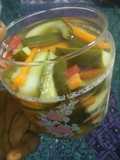 Pickled cucumber & carrot accompanied with freshgreen & red chillies