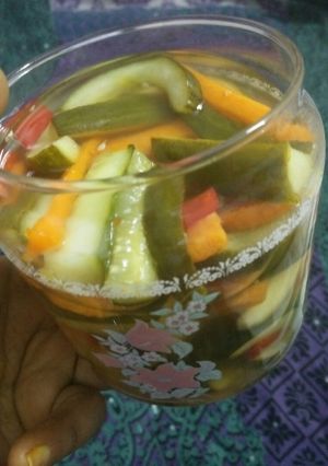 A picture of Pickled cucumber & carrot accompanied with freshgreen & red chillies.