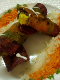 A picture of Tricolour paneer roll with salad and mayo.