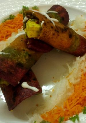 A picture of Tricolour paneer roll with salad and mayo.