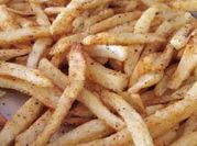 A picture of french fries with tomato sauce