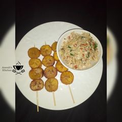 A picture of Scrambled egg with plantain kebab.