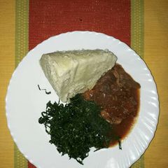 A picture of Ugali,beef wet fry with kales.