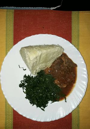 A picture of Ugali,beef wet fry with kales.