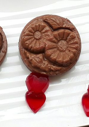 A picture of Chocolate budino with strawberry hearts.
