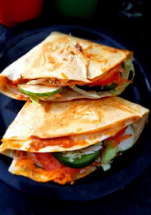 A picture of Tortilla Wrap with egg and veggies.