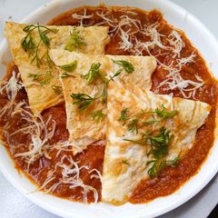 A picture of Egg samosa with gravy.