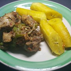 A picture of Chicken Asun  served with boiled plantain.