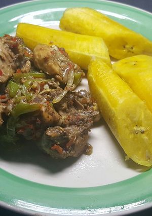 A picture of Chicken Asun  served with boiled plantain.