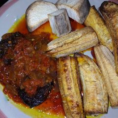 A picture of Roasted plantain n yam with sauce.