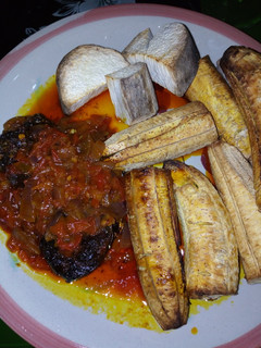 A picture of Roasted plantain n yam with sauce.