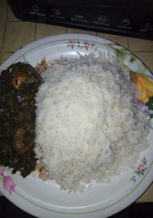 A picture of Vegetable soup with white rice.