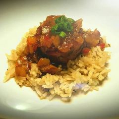 A picture of Prosciutto wrapped scallop with dirty rice.