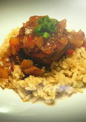 A picture of Prosciutto wrapped scallop with dirty rice.