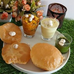A picture of Varat special, poory bhaji, chattny, makhany ki kher.