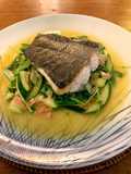 Ragout of sautéed turbot with Serrano ham, spring vegetable and pea shoots