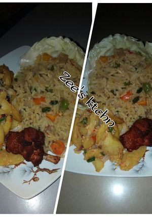 A picture of Jollof rice with potatoes and fried chicken.