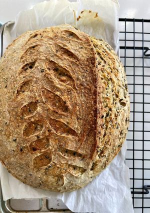 A picture of Turmeric Mixed Sesame Sourdough 🍞🌾 (Sourdough Bread with Turmeric, Mixed Sesame, and Herb Powder).