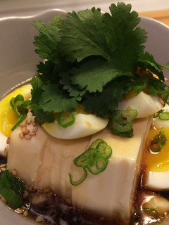 A picture of Silky tofu and half boiled egg with special sauce.