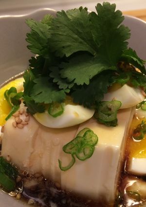 A picture of Silky tofu and half boiled egg with special sauce.