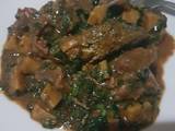 Platain porridge with diced meat, ugu leaves & oven grilled fish