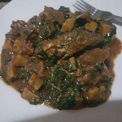 Platain porridge with diced meat, ugu leaves & oven grilled fish A picture of Platain porridge with diced meat, ugu leaves & oven grilled fish.